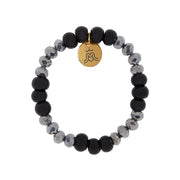 A bracelet with black ceramic and silver tone plated crystal cut glass beads with gold plaed Goddess charm