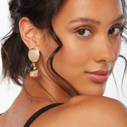 Brunette wearing a pair of dangling earrings with sunstone, hematite, and plated crystal cut glass in gold, silver, gunmetal and brown tones with oval gold plated posts