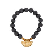 A bracelet of hematite beads, gold plated brass squares and Greek inspired semi circle focal metal element