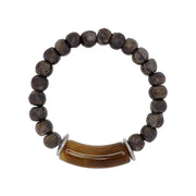 A bracelet in brown/silver tones with ceramic beads, silver plated discs and a focal horn-like acrylic bead