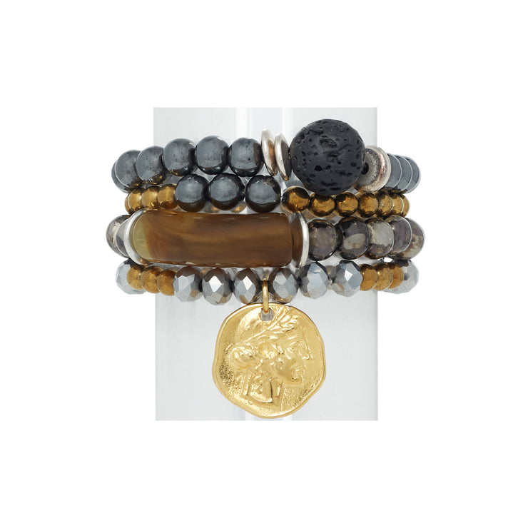 A set of 4 bracelets in mixed metal tones with gold tone coin and a focal acrylic horn-like bead