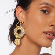 Brunette wearing dramatic pair of long statement earrings with hand crocheted drops, gold plated Greek coins, gold plated posts and silver tone plated crystal cut glass beads.