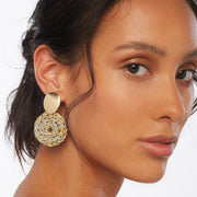 Brunette wearing a pair of hand crocheted front facing hoops in mized metal tones and oval gold tone earring posts 